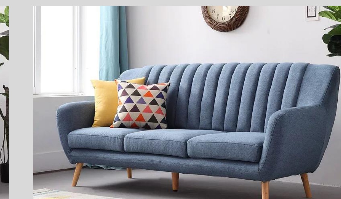 Blue three-seat sofa with vertical channel back and tapered timber legs
