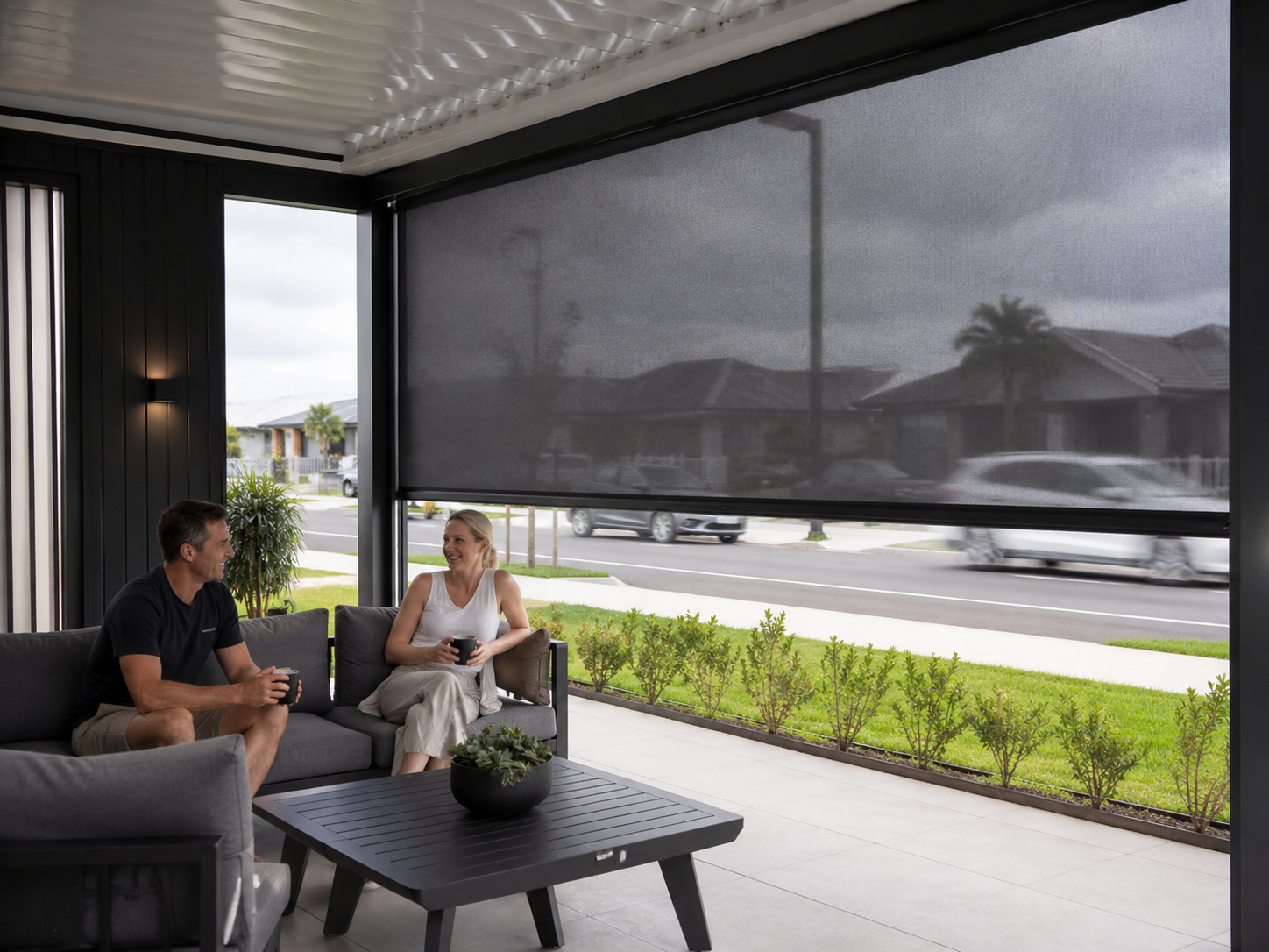 Covered residential patio with a large dark mesh outdoor screen
