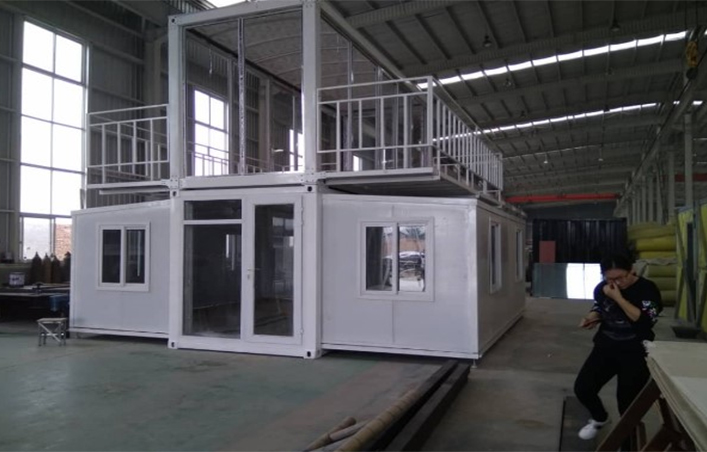 Two-storey expandable modular building configuration shown inside a factory