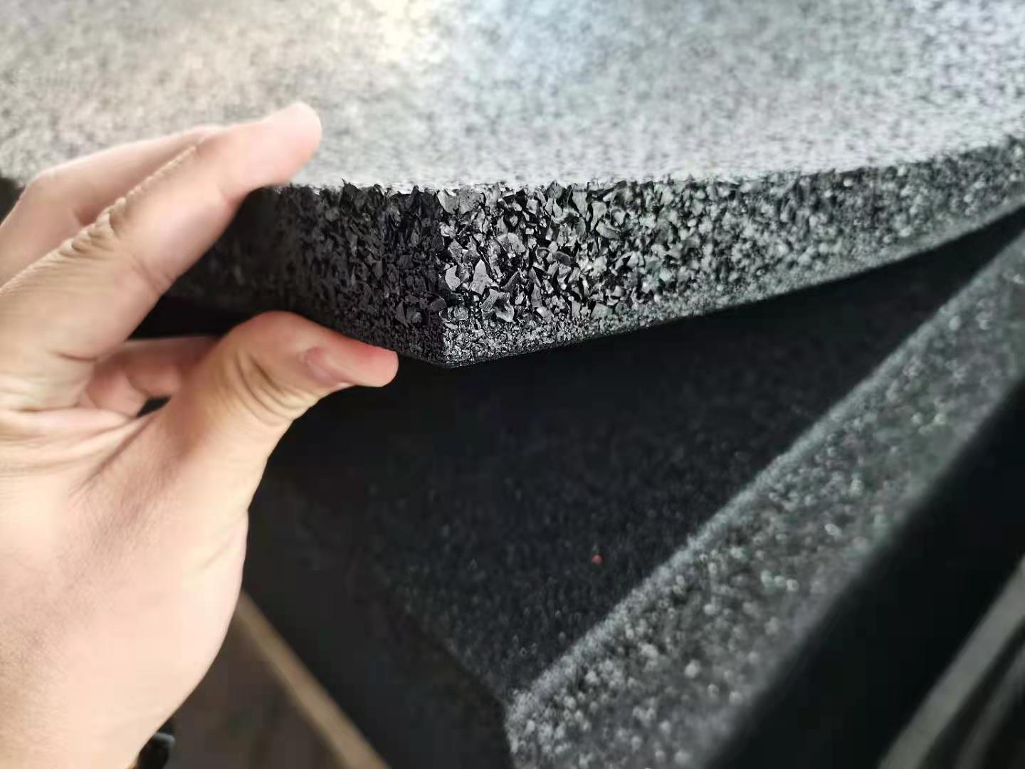 Close-up cross-section of thick impact rubber gym flooring