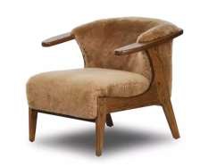 Warm upholstered lounge chair with sculpted timber arms and tapered timber legs