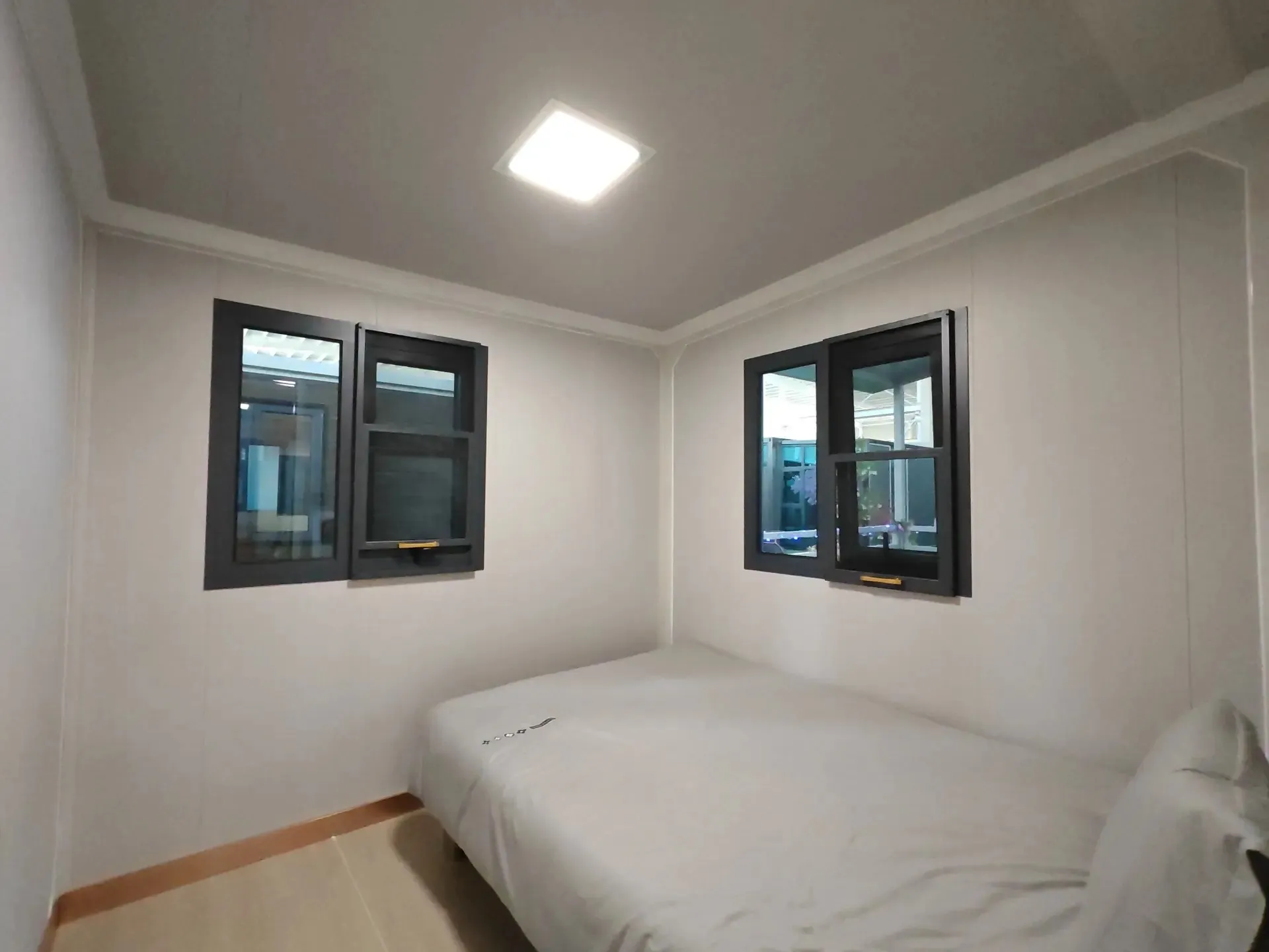 Compact Montara modular bedroom with two dark-framed windows