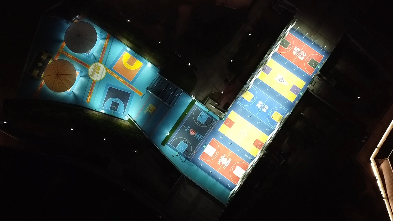 Night aerial view of colourful custom basketball courts