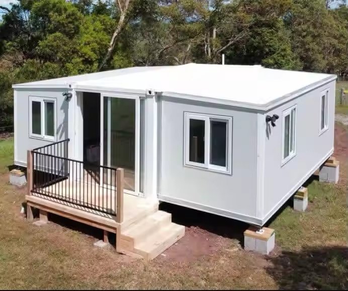 White Montara expandable modular building deployed on simple supports with front steps