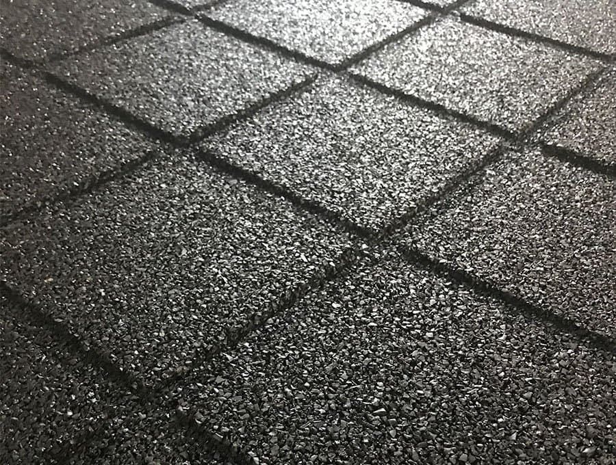 Close-up of textured black rubber flooring surface