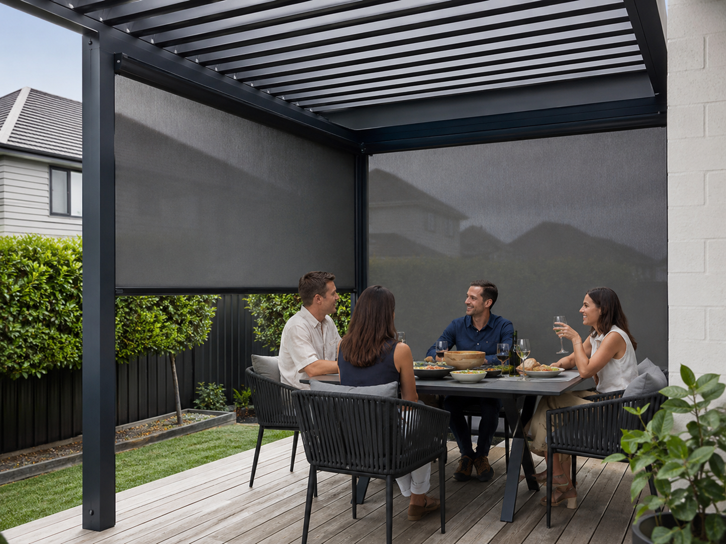 Outdoor dining area enclosed with large dark mesh guided blinds