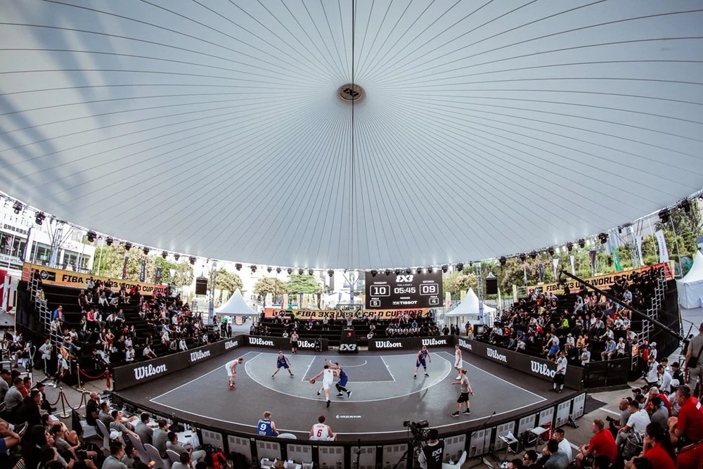 Covered FIBA 3x3 tournament court surrounded by spectators