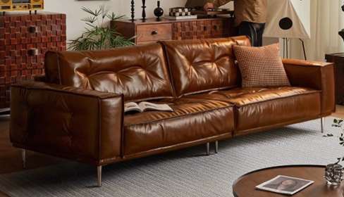Warm brown Mid-Century sofa with slim raised legs and loose back cushions