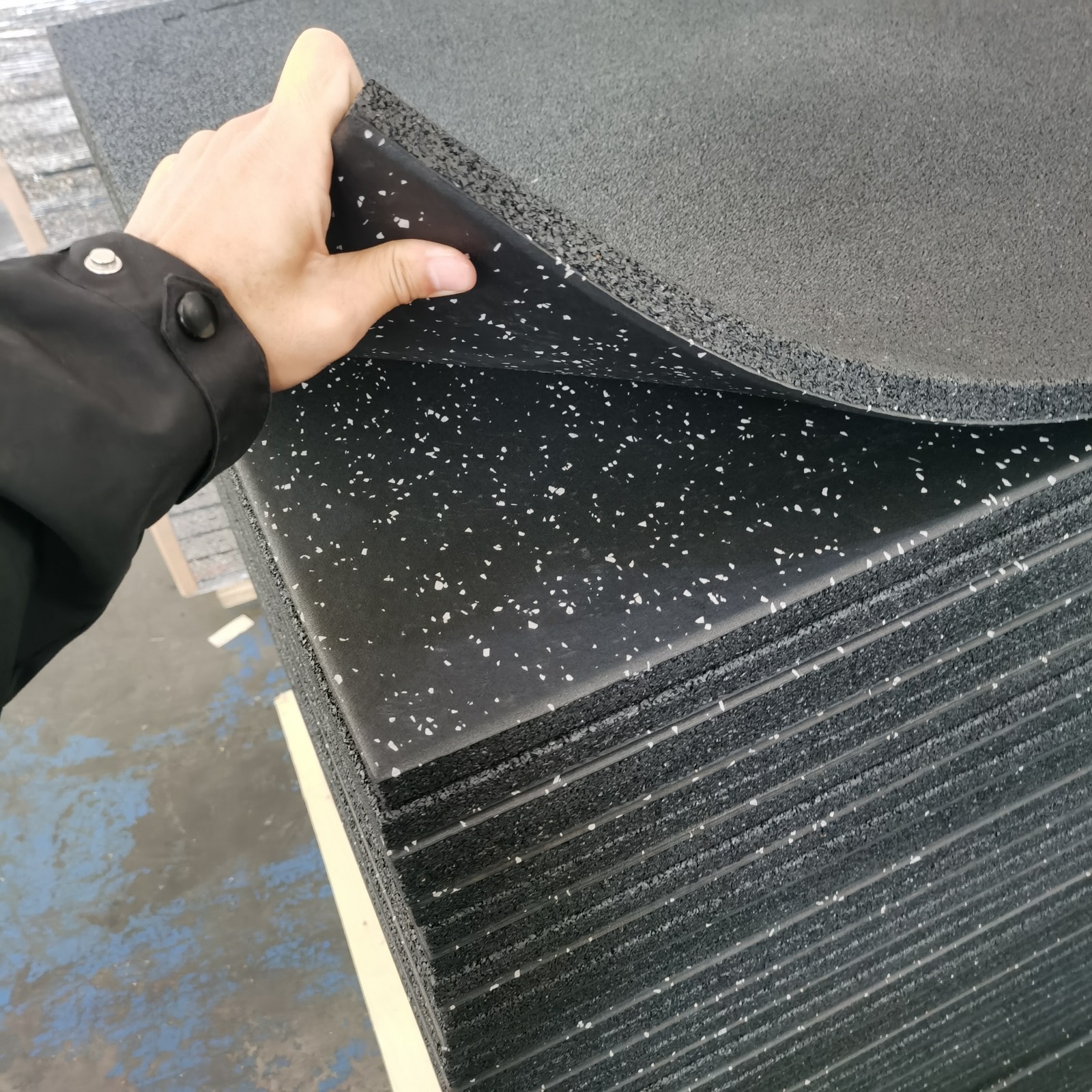 Flexible layered rubber gym flooring showing surface and impact layer construction