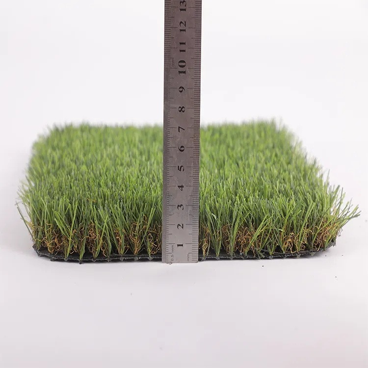 Artificial turf sample beside a ruler showing pile depth