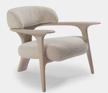 Pale Nordic lounge chair with curved timber arms and textured upholstery