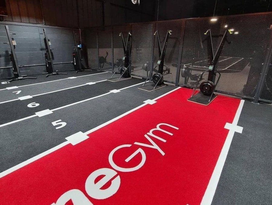 Black and red functional fitness floor with numbered training lanes