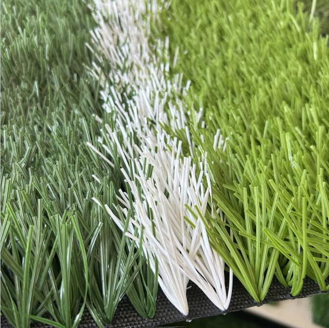 Artificial sports grass with a white field marking
