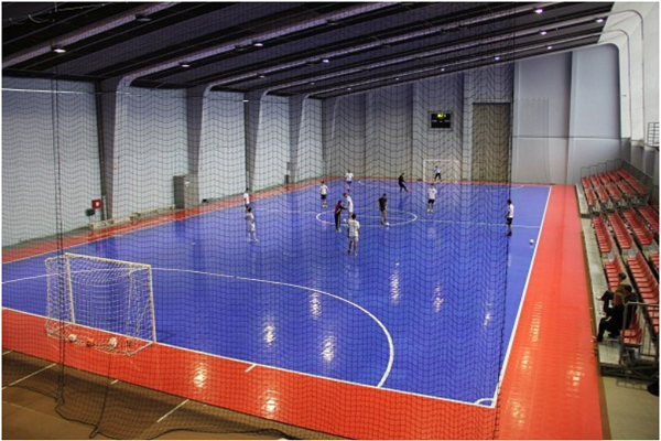 Netted indoor futsal court with blue modular flooring