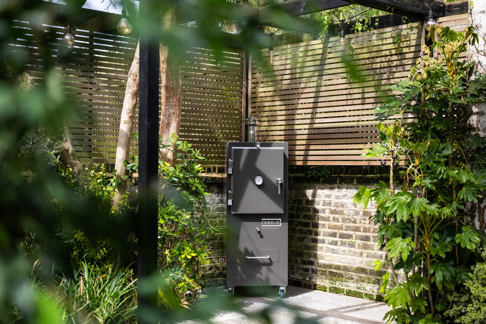 Porcini Charlie Professional Oven in a landscaped courtyard