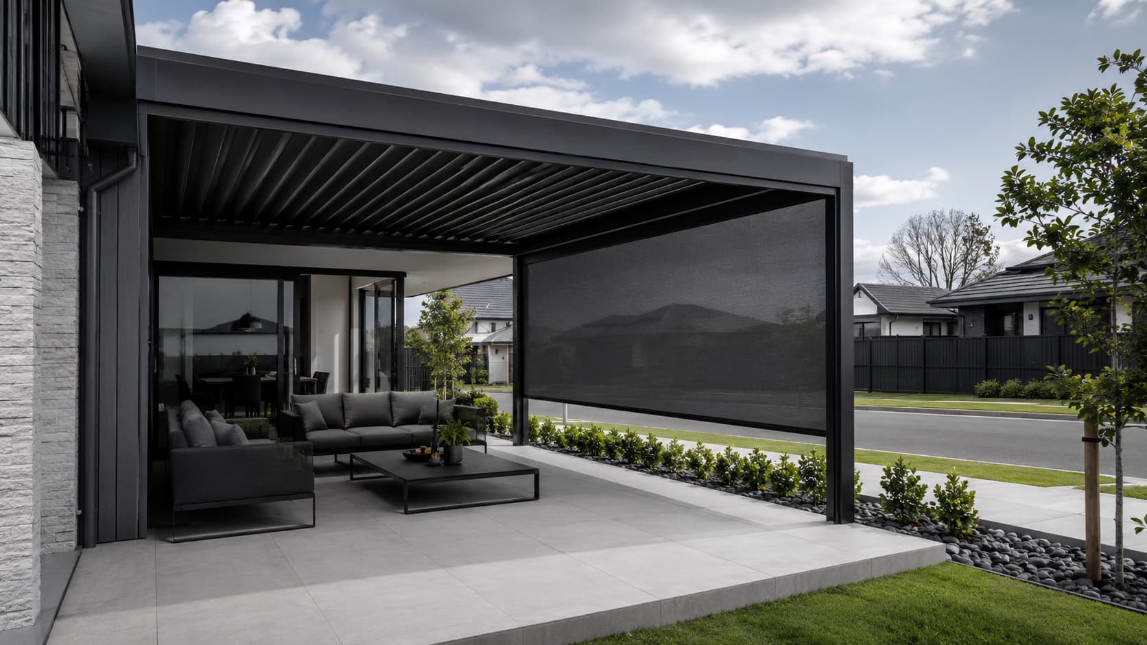 Residential covered outdoor lounge protected by a large guided mesh screen