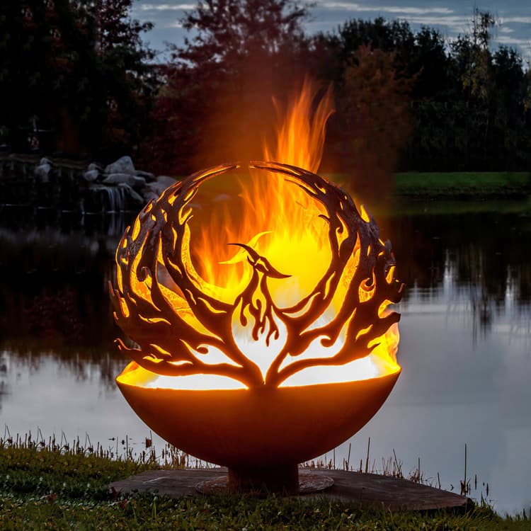 Decorative spherical Corten steel Fire Ball sculpture with laser-cut bird motif and live flame