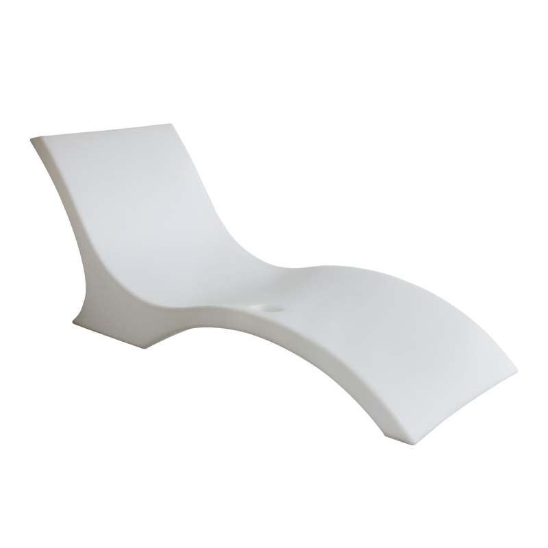White sculpted in-pool lounger for a shallow pool shelf