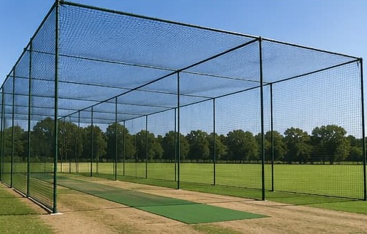 Multiple outdoor cricket practice cages arranged side by side
