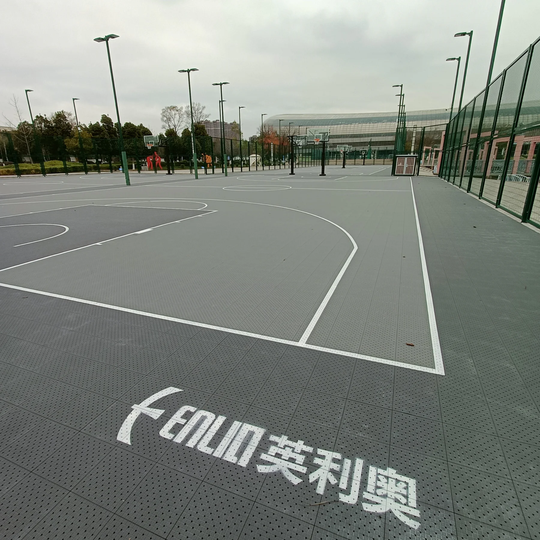 Large grey outdoor multi-court basketball installation