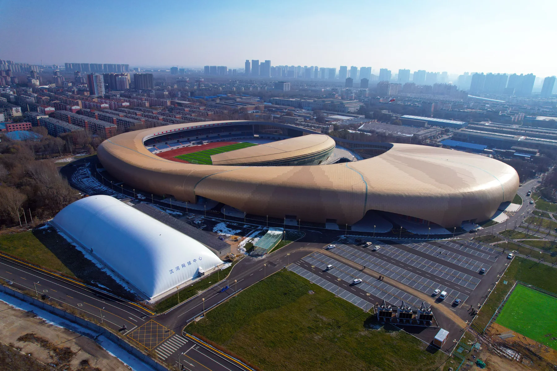 Air-supported sports dome positioned beside a major stadium complex