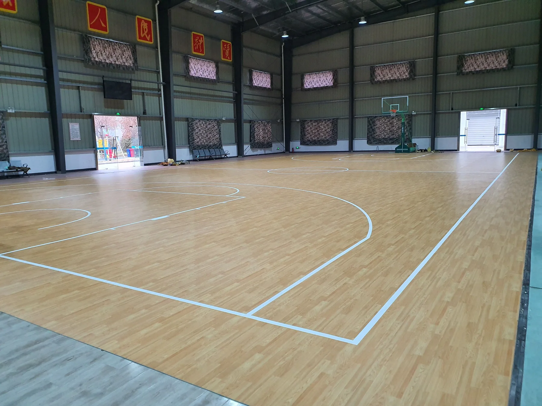 Arena basketball court with pale wood-pattern sports floor