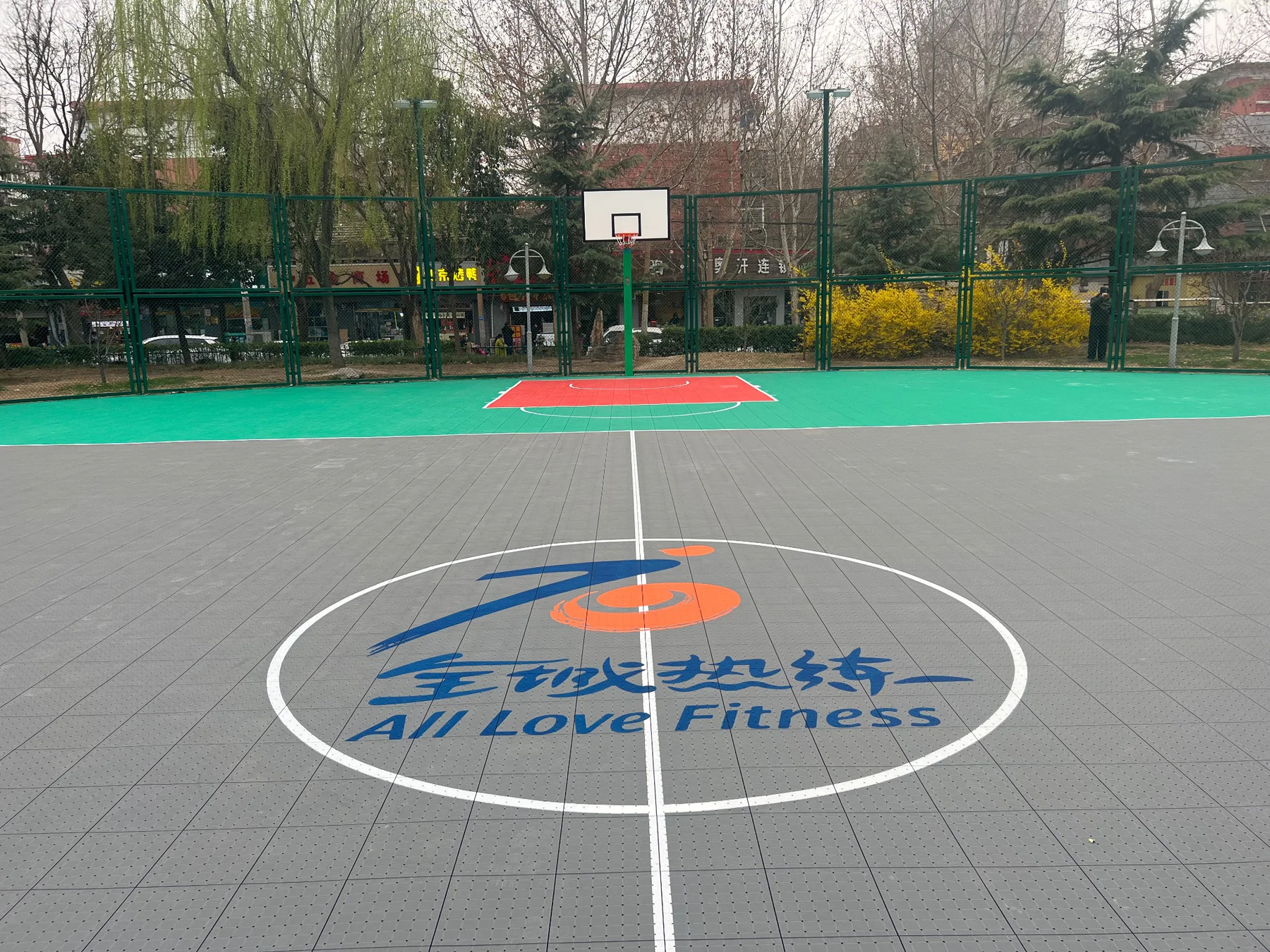 Grey and green community modular basketball court