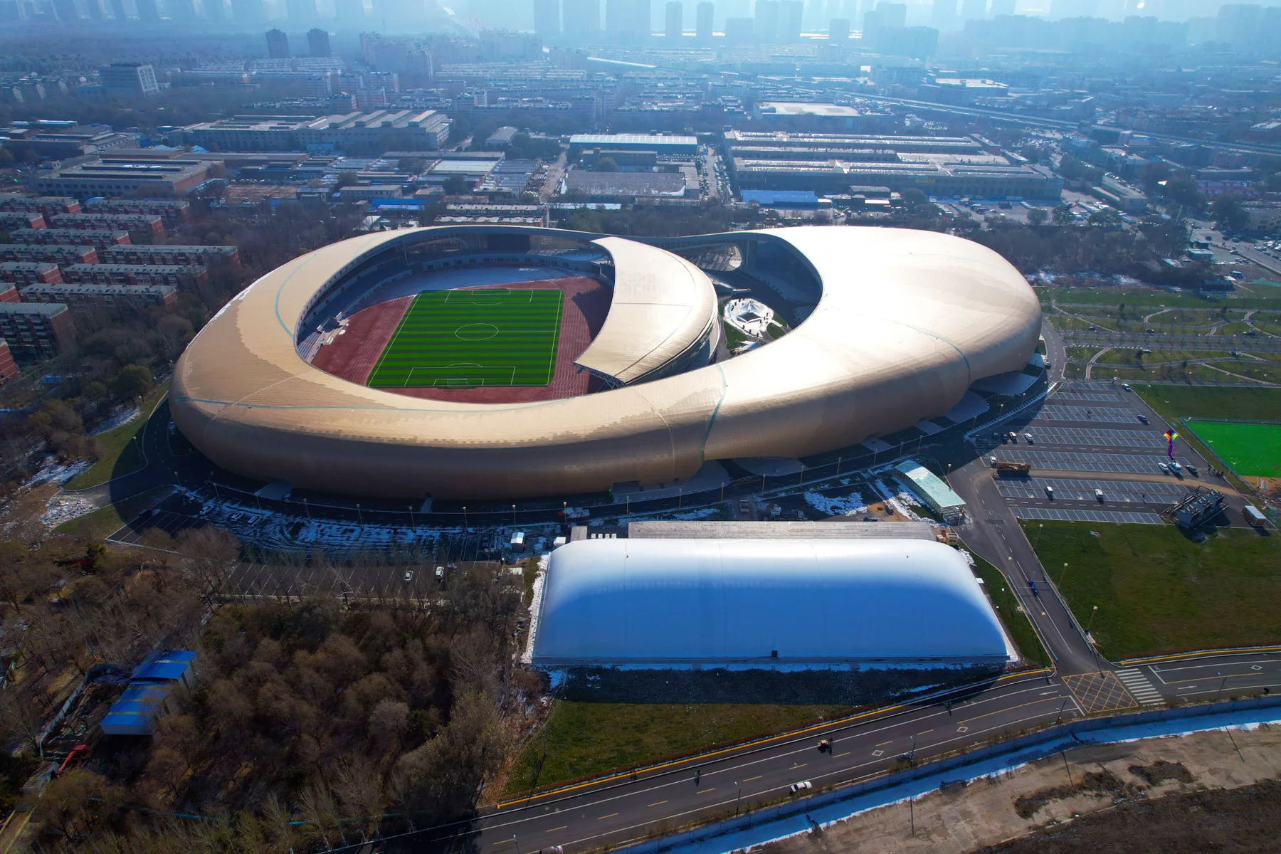 High aerial view of an air-supported dome beside a large stadium